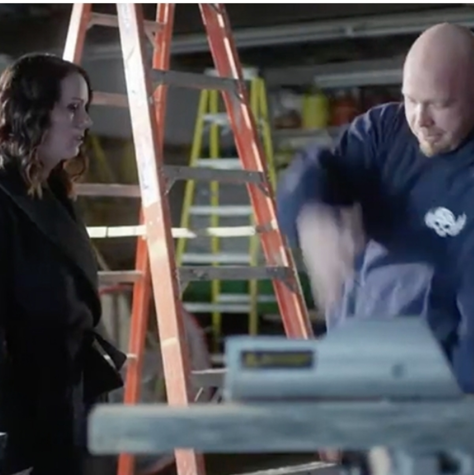 Lawyer observing a worker in warehouse.