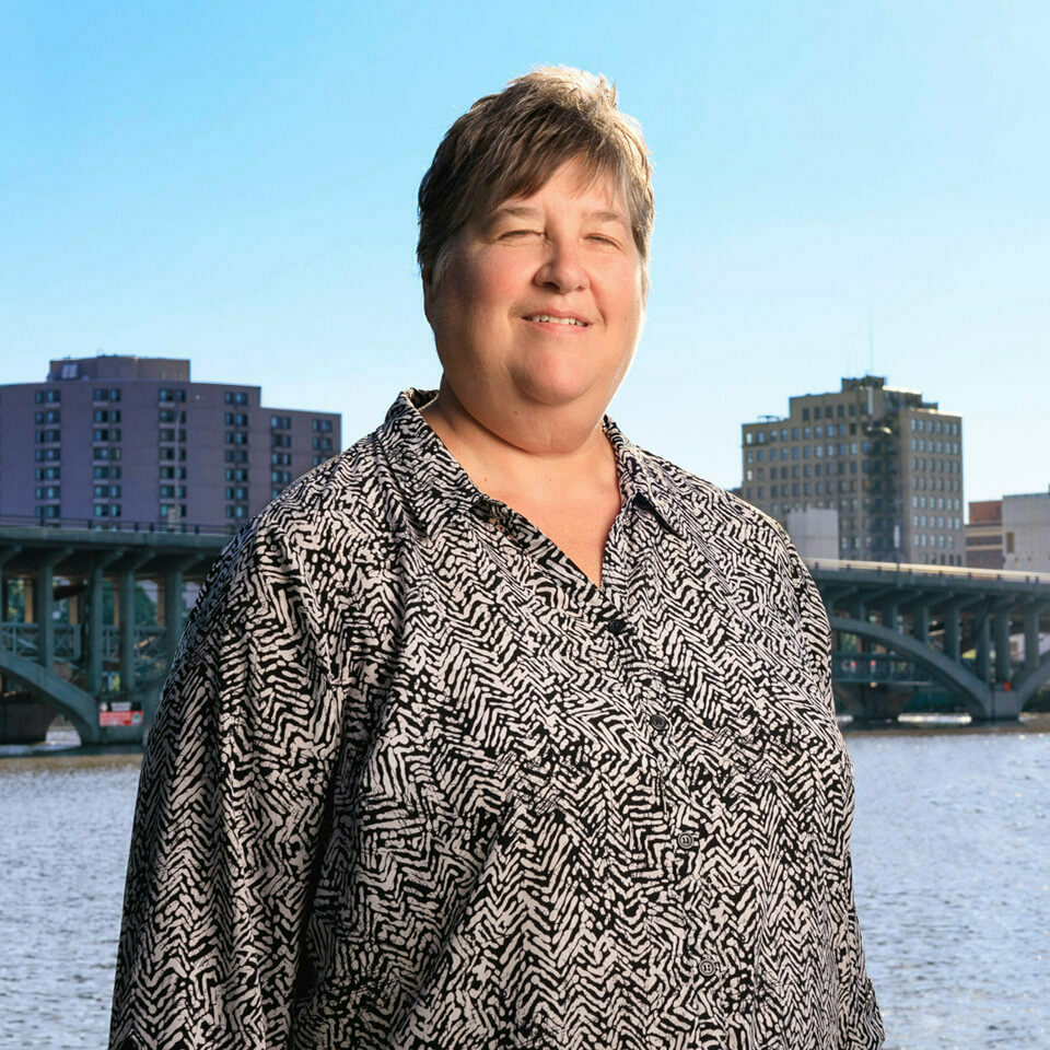 Headshot of Sharon Haas with outdoor background.