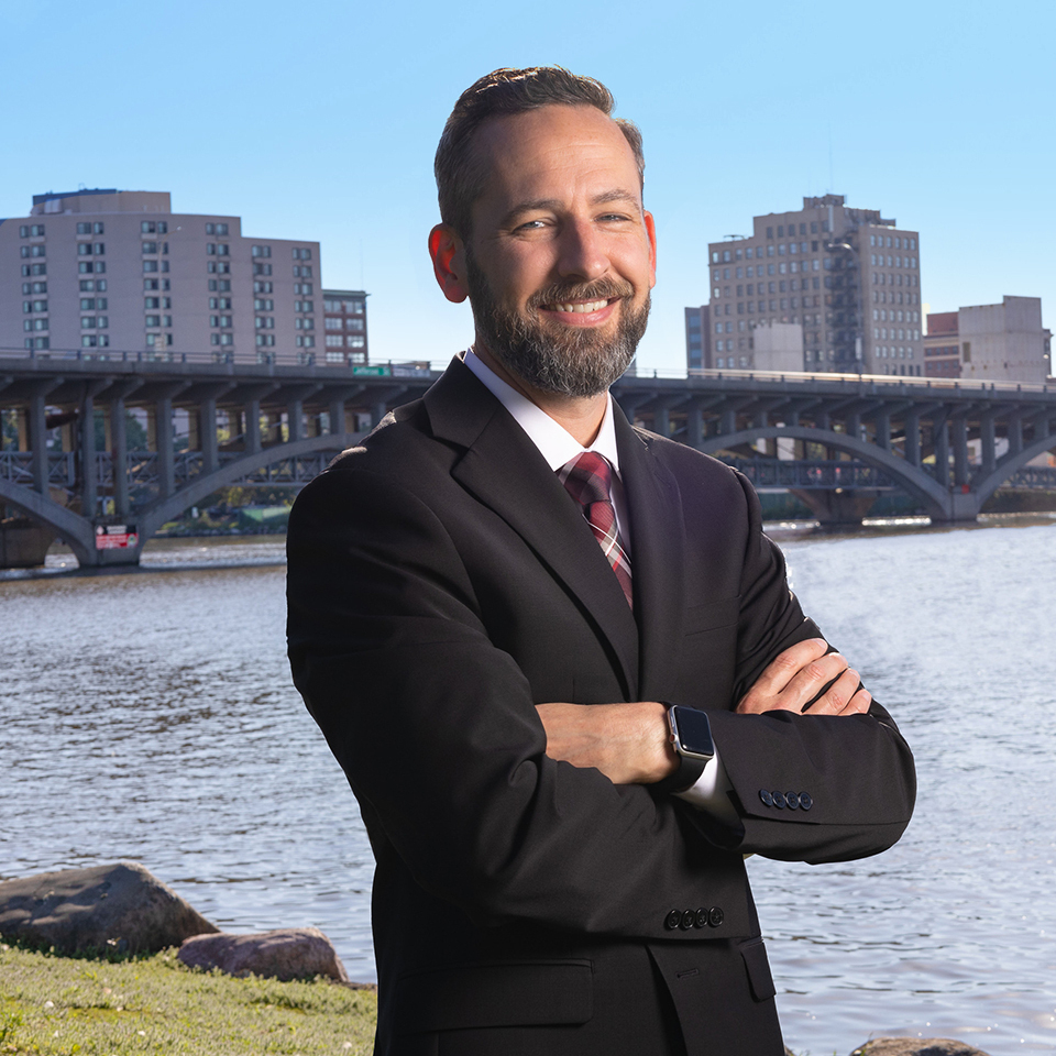 Headshot of Jason Esmond with outdoor background.