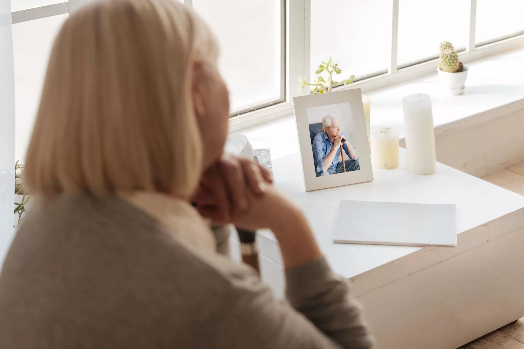 Woman looking at picture of her husband