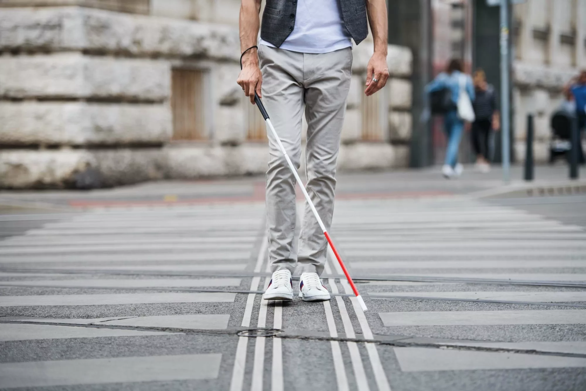 person walking with blindness walking stick