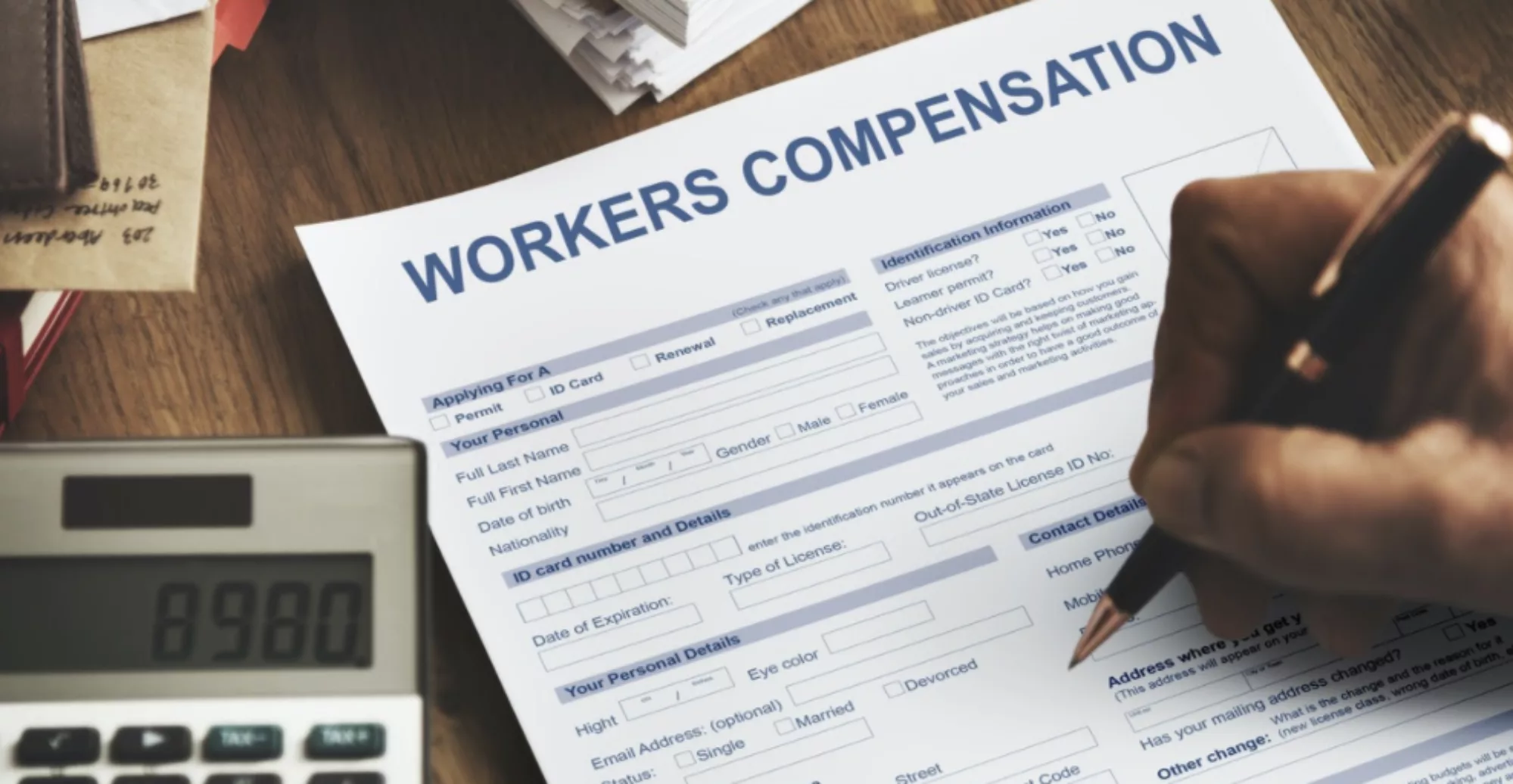 Close up of person filling out workers' compensation form.