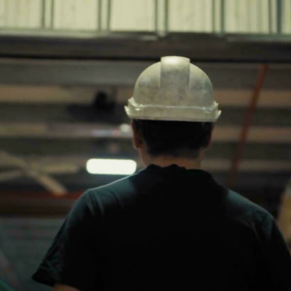Worker in a white construction helmet.