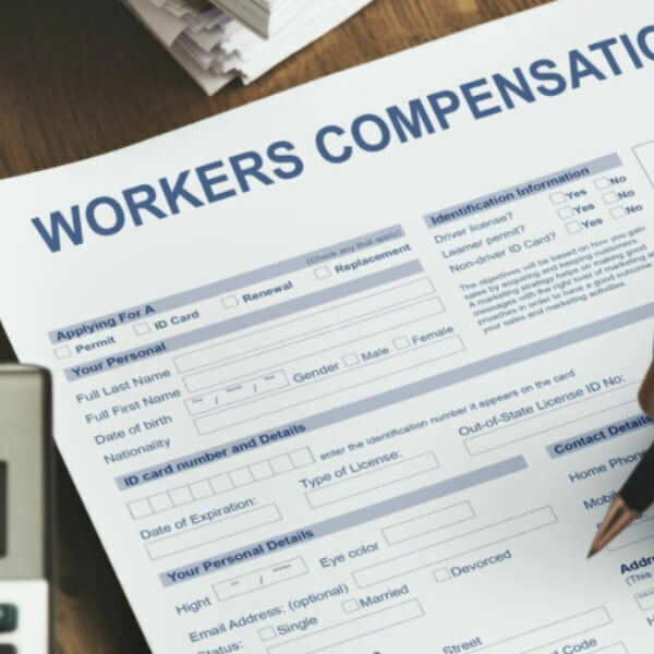 Close up of person filling out workers' compensation form.
