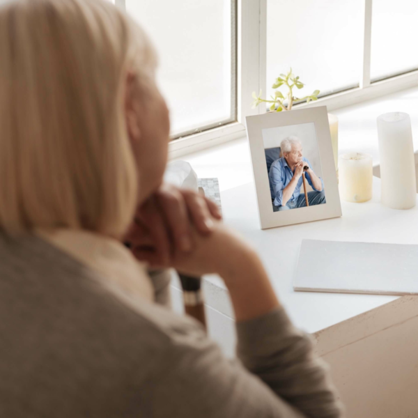 Woman looking at picture of her husband