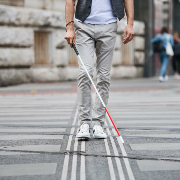 person walking with blindness walking stick