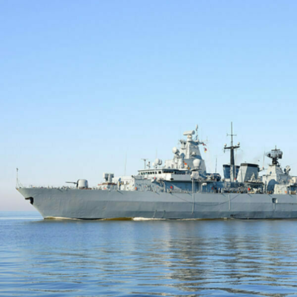 Navy ship in a body of water.