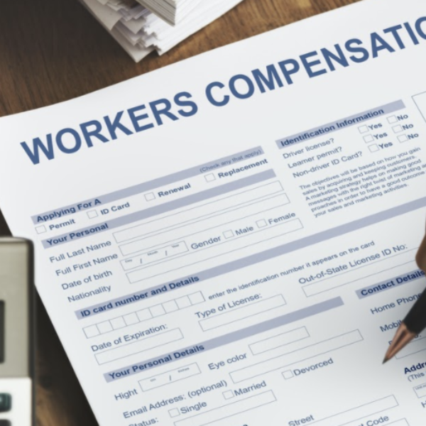 Close up of person filling out workers' compensation form.