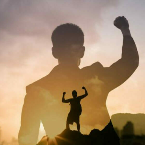 Silhouette of man with a celebratory fist in the air.