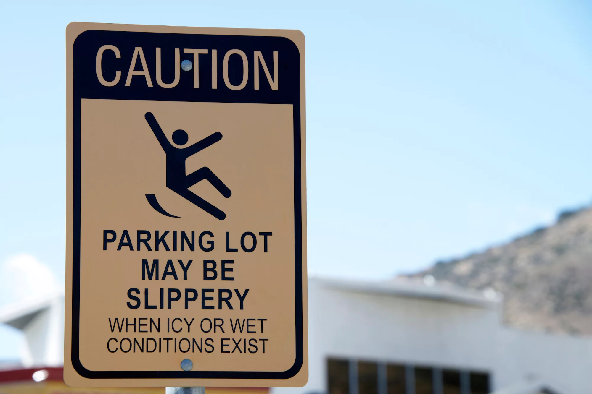 "Caution parking lot may be slippery" sign.